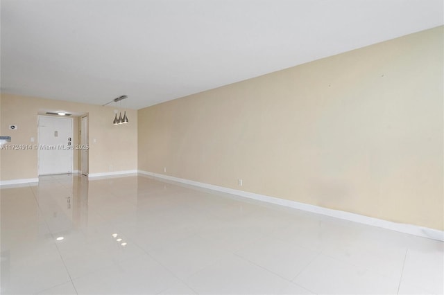 spare room featuring light tile patterned flooring