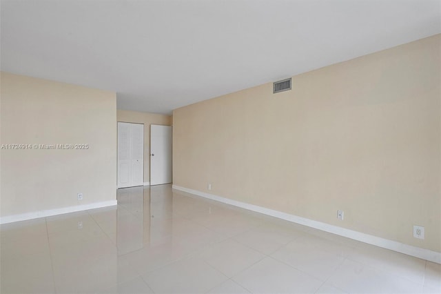 spare room featuring light tile patterned floors