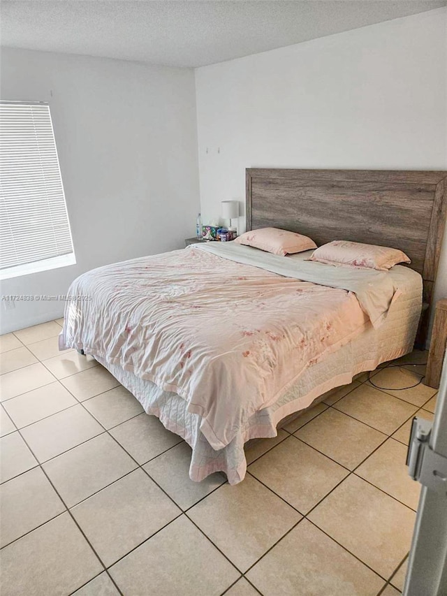 tiled bedroom with a textured ceiling