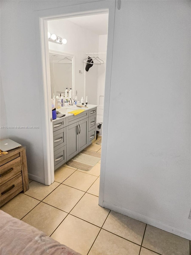 bathroom featuring tile patterned flooring and vanity