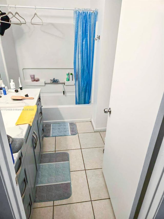 bathroom with tile patterned flooring, vanity, and shower / tub combo