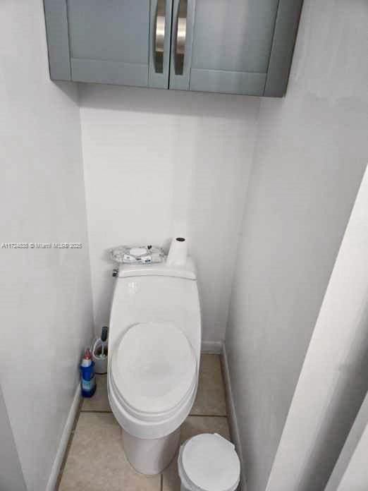 bathroom featuring tile patterned flooring and toilet