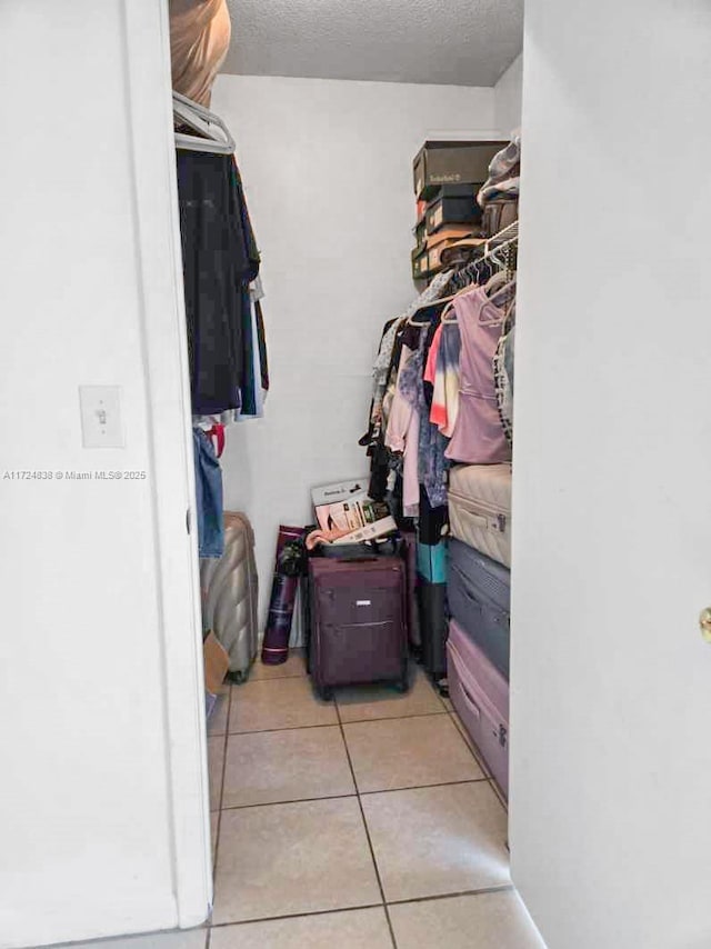 spacious closet featuring light tile patterned floors