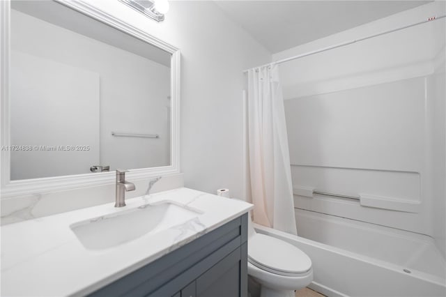 full bathroom with shower / tub combo with curtain, vanity, and toilet