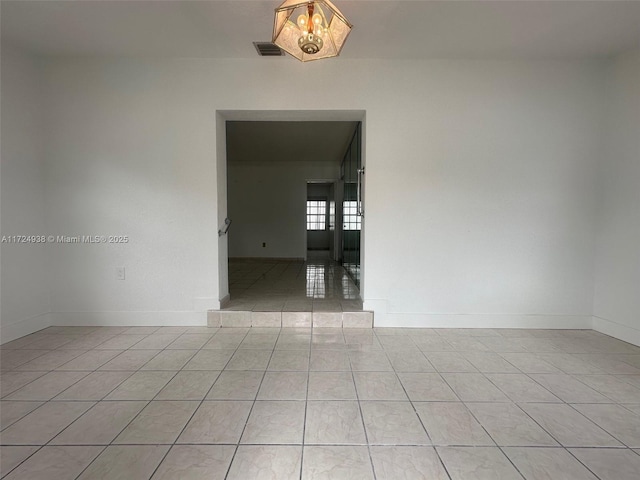 unfurnished room featuring light tile patterned floors