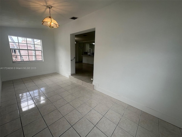 unfurnished room featuring light tile patterned floors