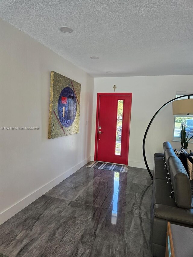 entryway featuring a textured ceiling