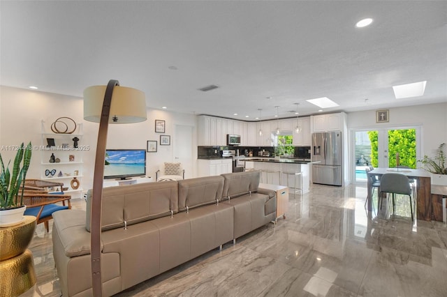 15100 SW 89th Ct, Palmetto Bay, FL 33176 - living room featuring recessed lighting, a skylight, visible vents, and marble finish floor