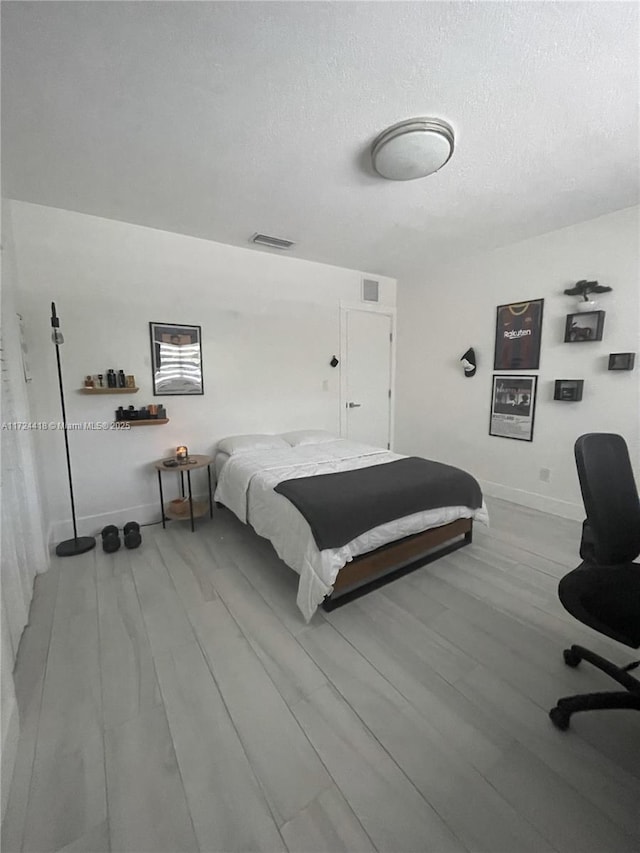 bedroom with hardwood / wood-style flooring