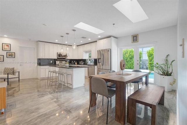 15100 SW 89th Ct, Palmetto Bay, FL 33176 - dining space featuring recessed lighting, marble finish floor, and a skylight