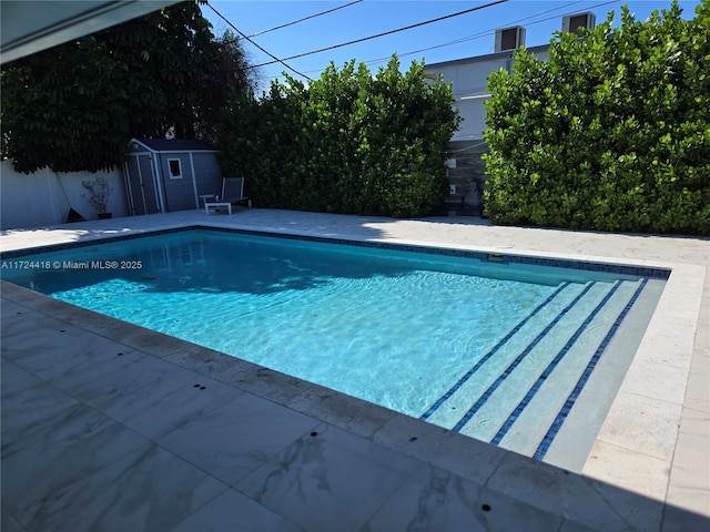 view of pool with a shed