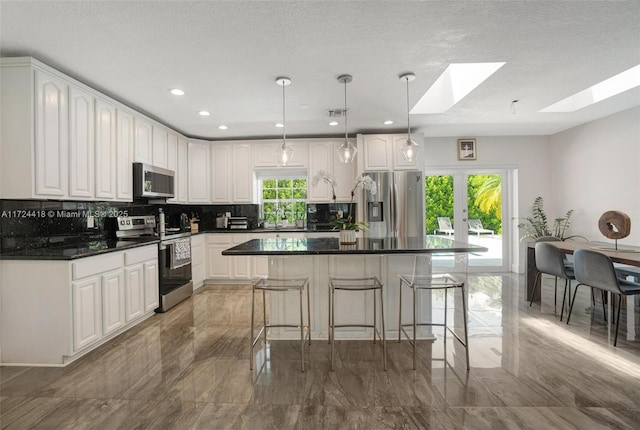 15100 SW 89th Ct, Palmetto Bay, FL 33176 - kitchen featuring dark countertops, appliances with stainless steel finishes, marble finish floor, white cabinetry, and backsplash