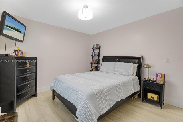 15100 SW 89th Ct, Palmetto Bay, FL 33176 - bedroom featuring baseboards and light wood-type flooring