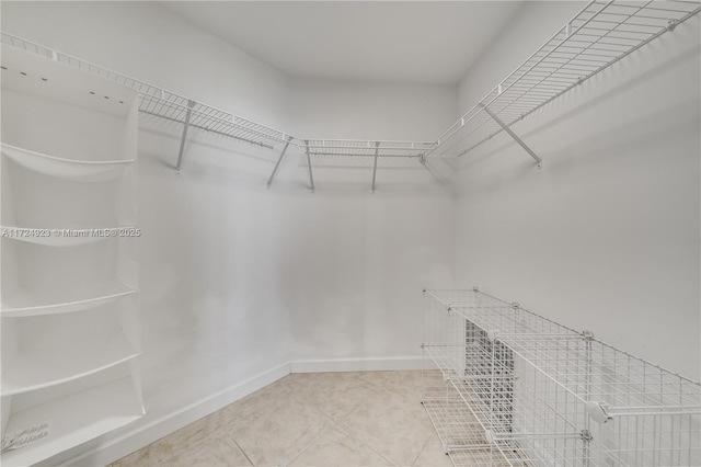 spacious closet featuring tile patterned flooring