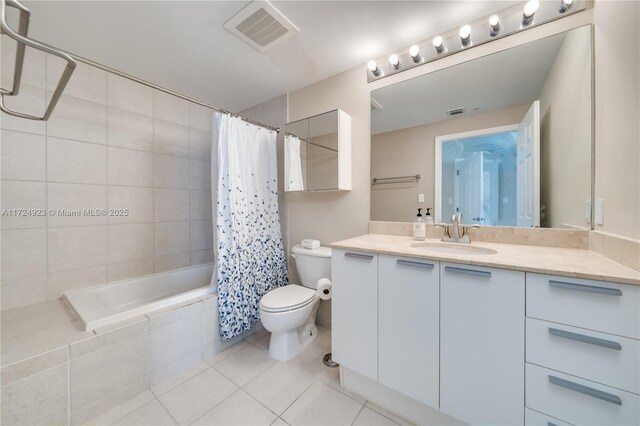 full bathroom featuring tile patterned floors, shower / bath combo with shower curtain, vanity, and toilet