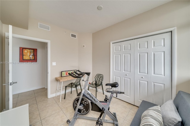 workout room featuring light tile patterned floors