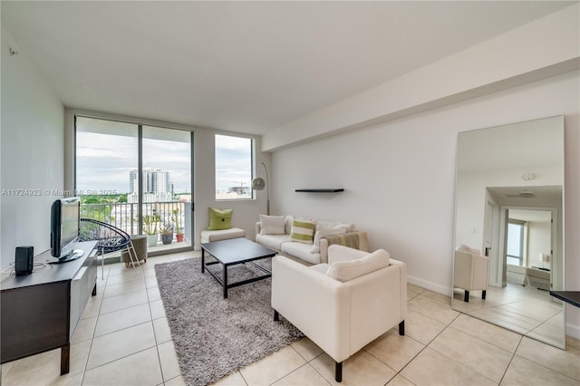 living room with light tile patterned floors and a wall of windows