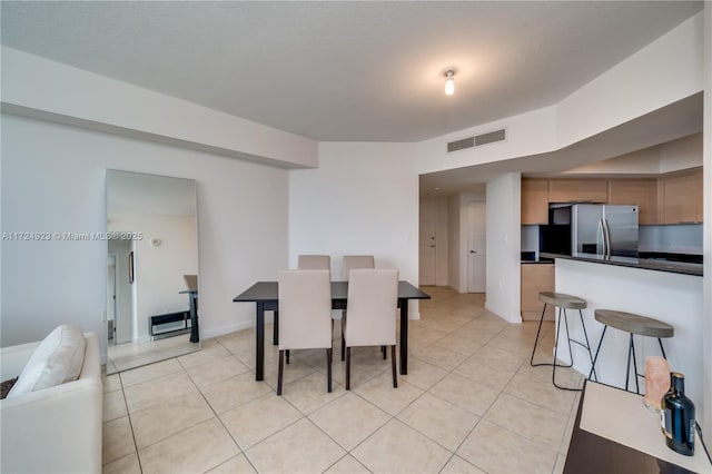 dining space featuring light tile patterned flooring