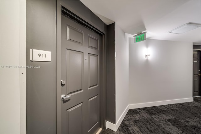 hallway with dark carpet