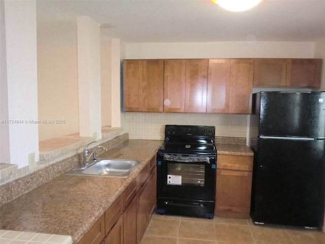 kitchen with black appliances, backsplash, and sink