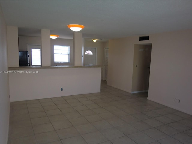 spare room featuring light tile patterned floors