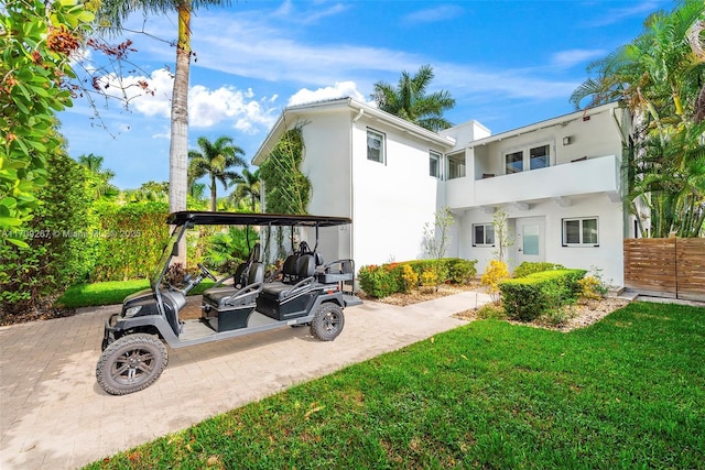 view of yard featuring a balcony and fence