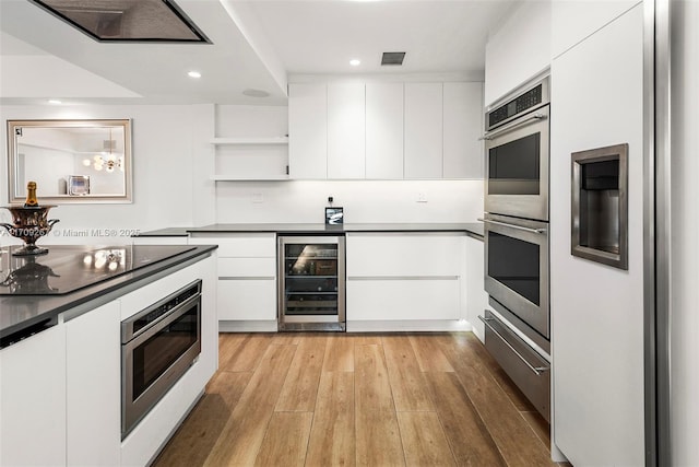 kitchen featuring modern cabinets, open shelves, wine cooler, and appliances with stainless steel finishes