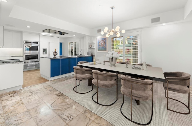 dining space featuring a notable chandelier, recessed lighting, and visible vents