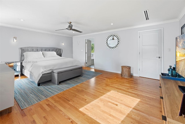 bedroom with ceiling fan, visible vents, wood finished floors, and crown molding