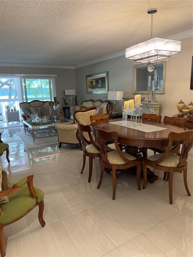 tiled dining area featuring ornamental molding, a textured ceiling, and a chandelier