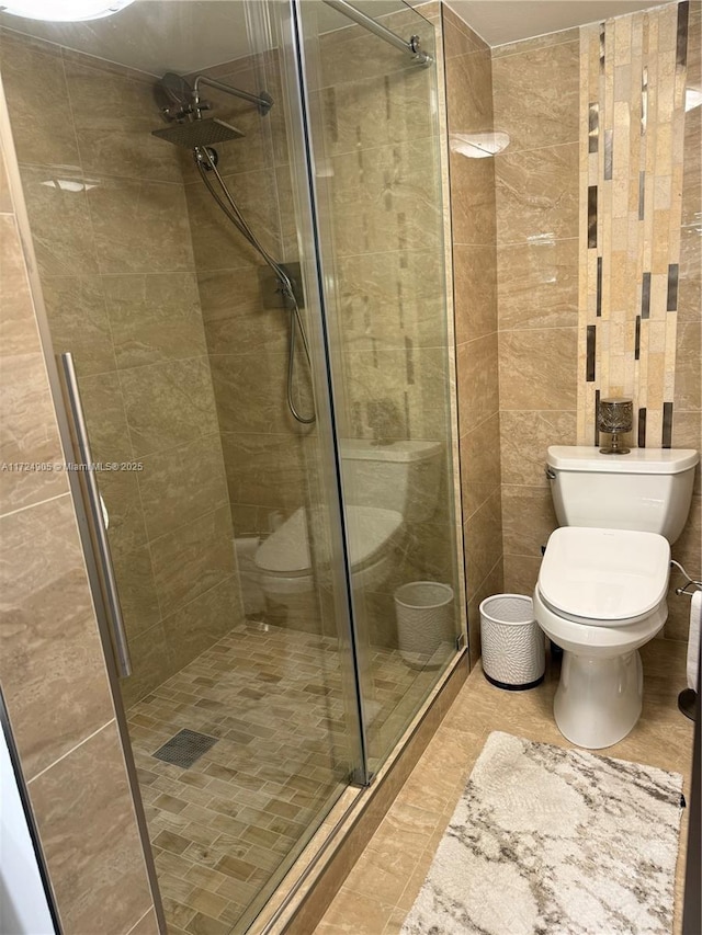 bathroom with toilet and an enclosed shower