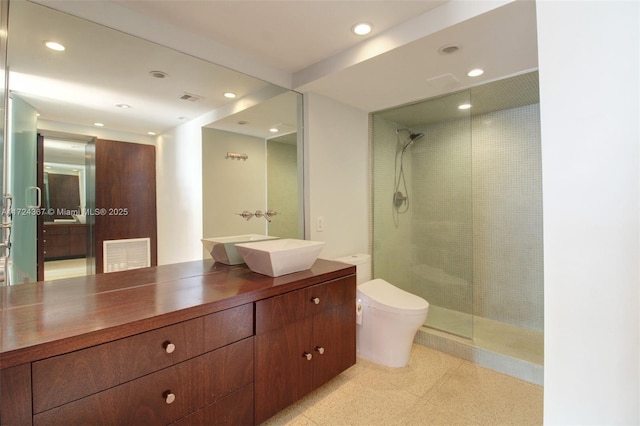 bathroom featuring vanity, toilet, and walk in shower