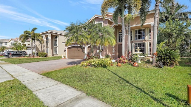 mediterranean / spanish-style house with a front lawn and a garage