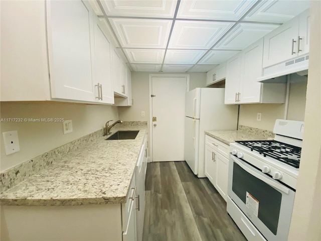 kitchen featuring white cabinets, light stone countertops, white appliances, and sink