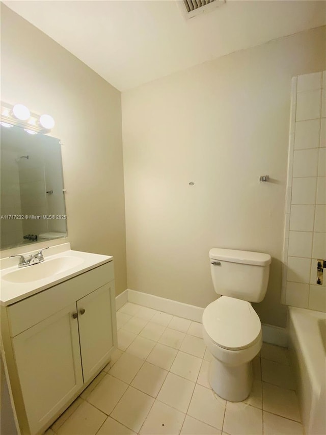 bathroom with tile patterned flooring, vanity, and toilet