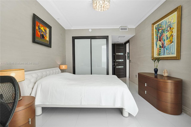 bedroom featuring a closet, ornamental molding, and a chandelier