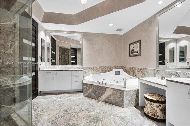 bathroom featuring separate shower and tub and vanity