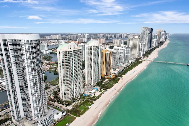 drone / aerial view featuring a beach view and a water view