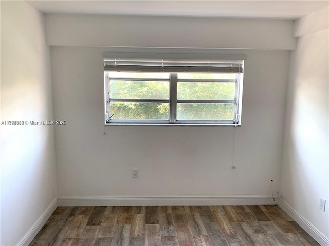 unfurnished room featuring dark hardwood / wood-style flooring