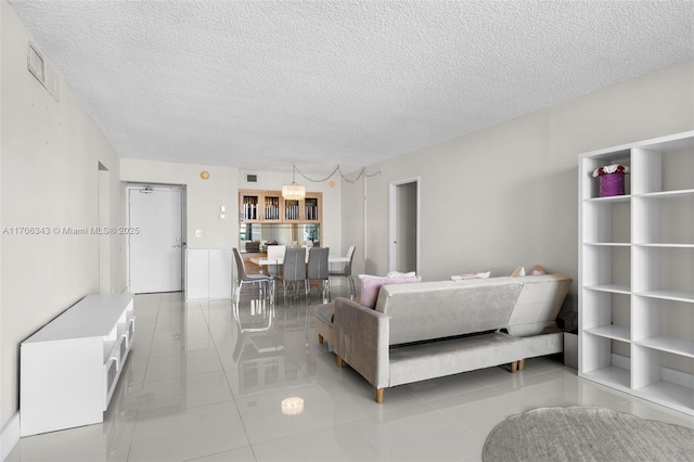 living room featuring a textured ceiling and light tile patterned flooring