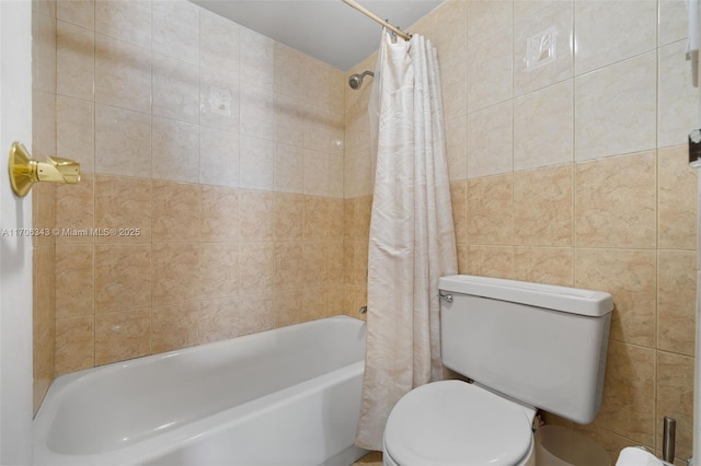 bathroom featuring shower / bathtub combination with curtain, tile walls, and toilet