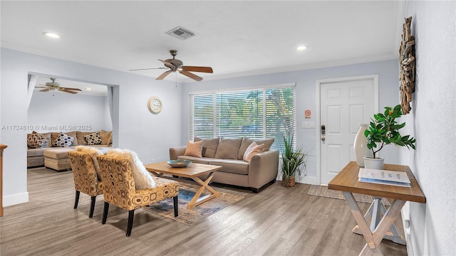 living room featuring ceiling fan and light wood-type flooring