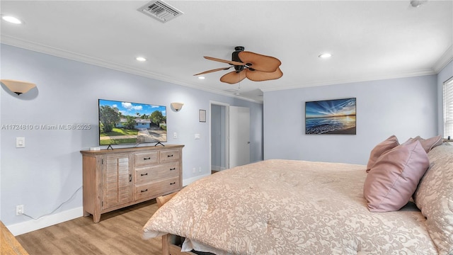 bedroom with ornamental molding, light wood-type flooring, and ceiling fan