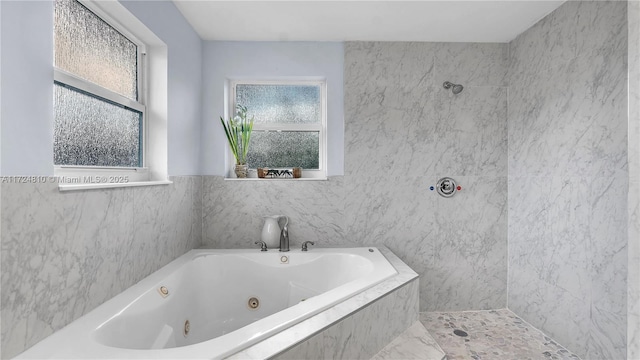 bathroom featuring tile walls and independent shower and bath