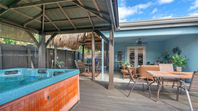 wooden deck with a gazebo, ceiling fan, and a hot tub