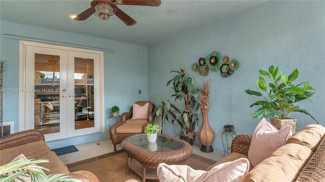 living room featuring ceiling fan and french doors