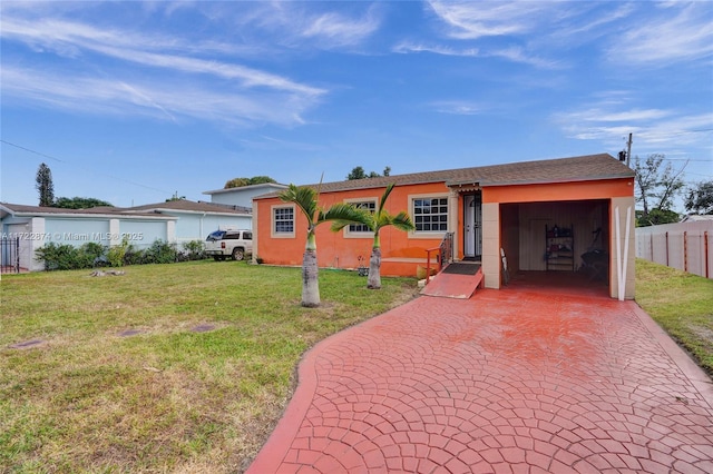 ranch-style home featuring a front yard and a garage