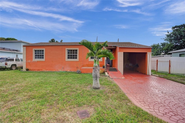 view of front of home with a front yard and a garage