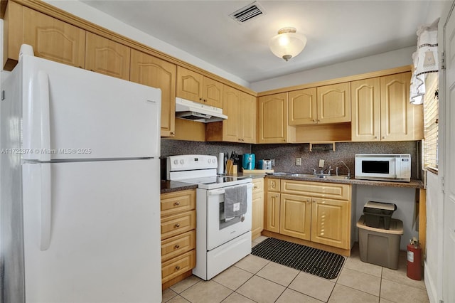 kitchen with light brown cabinetry, sink, light tile patterned floors, and white appliances