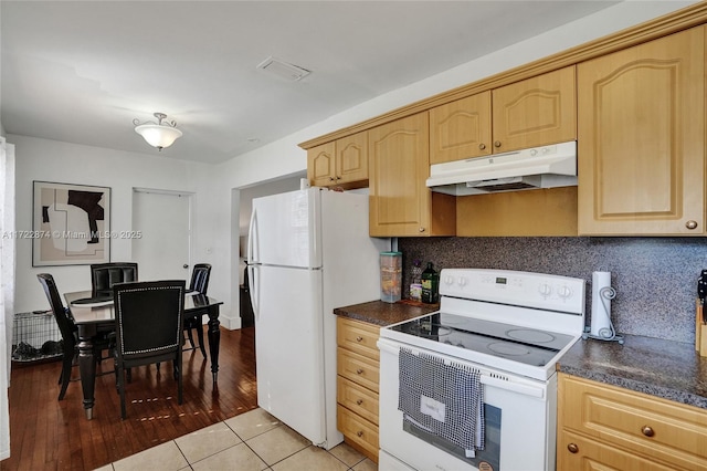 kitchen featuring white appliances, light brown cabinetry, light tile patterned floors, and tasteful backsplash